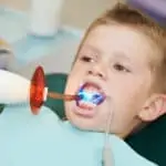 little boy receiving dental filling